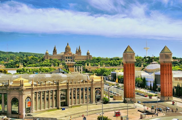Montjuïc hill and castle in Barcelona displaying bright colors at daylight and green trees